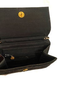 chanel black velvet bag with CC logo and chain.