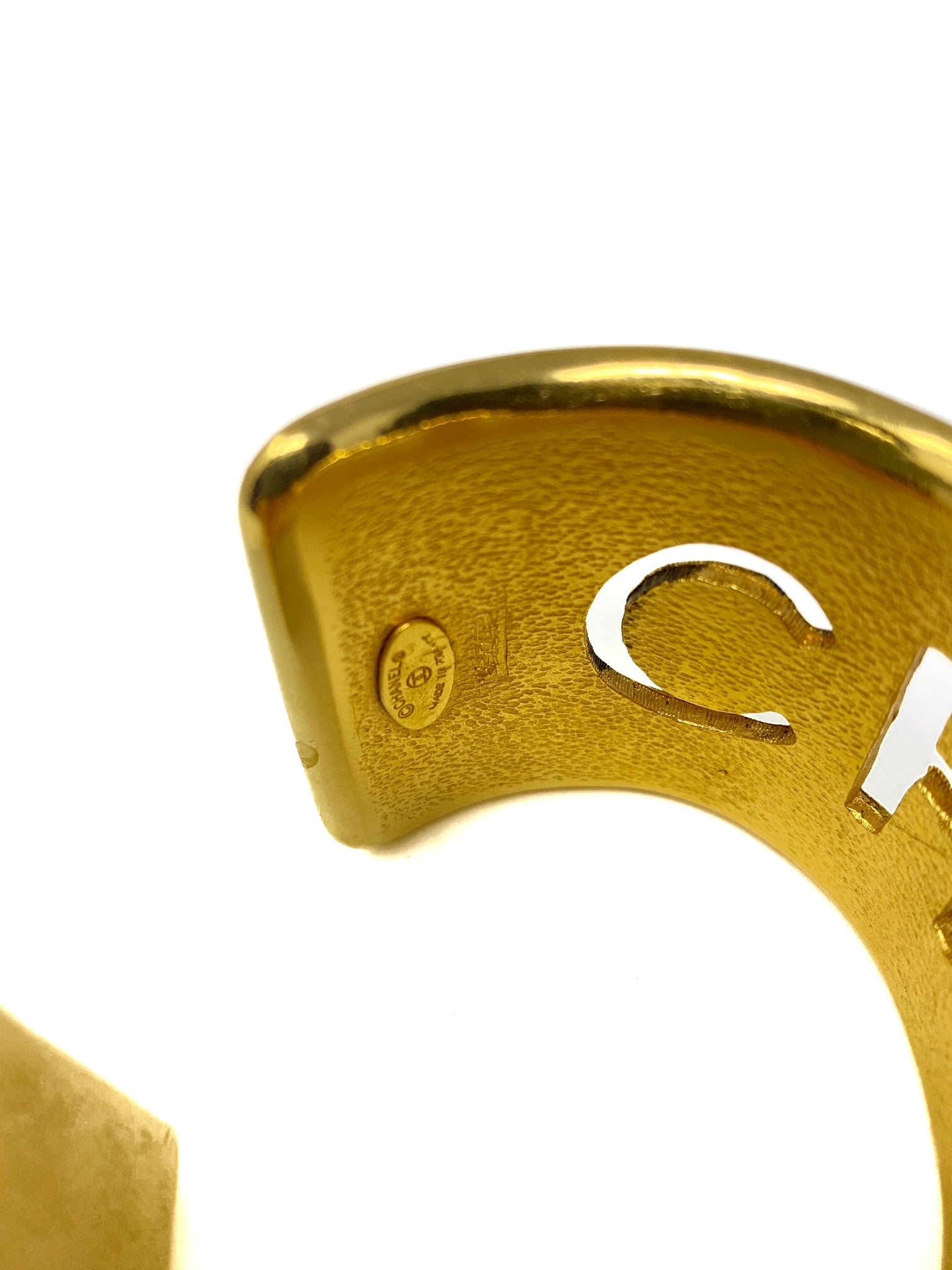 chanel gold bangle, quilted with logo cut-out.-bangle