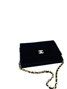 chanel black velvet bag with CC logo and chain.