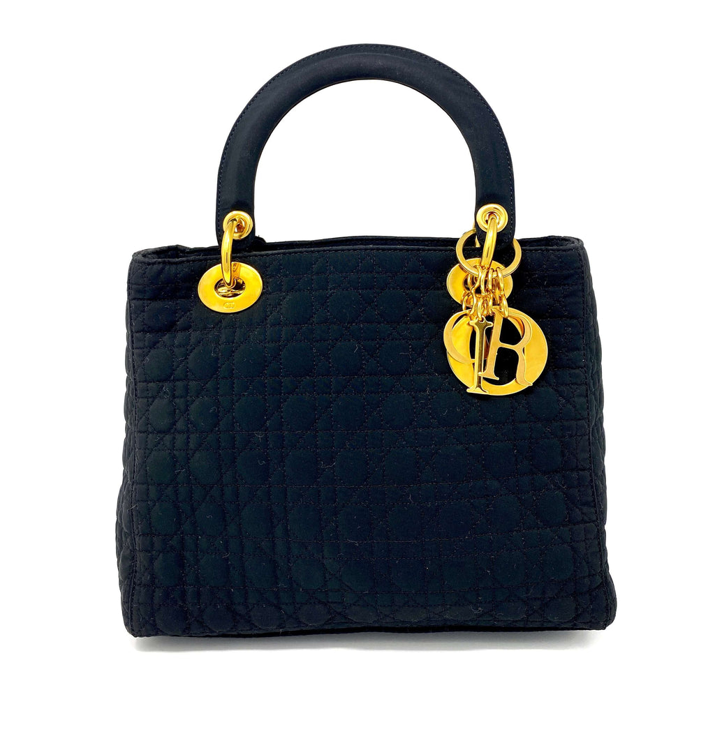 lady dior bag, black canvas, with Dior charms in gold.